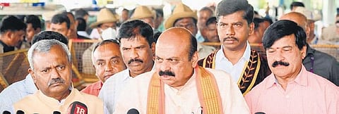 Chief Minister Basavaraj Bommai addresses the media after arriving in Mysuru on Sunday, as BJP leaders ST Somashekhar and SA Ramdas look on | Express
