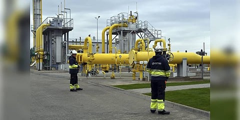 Workers stand near the pipelines. (Photo | AP)