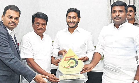 Chief Minister YS Jagan Mohan Reddy unveils the golden jubilee logo of APIIC at his camp office in Tadepalli on Monday | Express