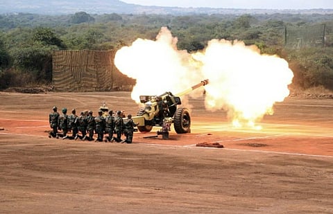 Artillery troops firing a gun..