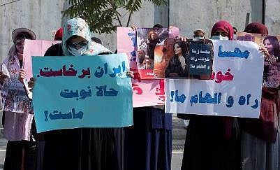 Afghan women hold placards as they take part in a protest in front of the Iranian embassy in Kabul on September 29, 2022. (Photo | AFP)