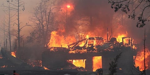 A residence goes up in flames as the Mill Fire causes damage in the Lake Shastina subdivision northwest of Weed, Calif. (Photo | AP)