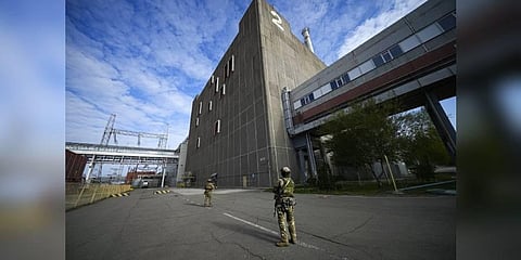 Russian servicemen guard an area of the Zaporizhzhia Nuclear Power Station, the largest nuclear power plant in Europe and among the 10 largest in the world in Enerhodar, Zaporizhzhia. (Photo | AP)