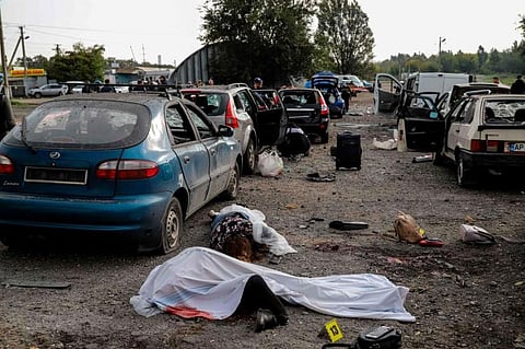 Bodies of civilians killed by a missile strike lay on a road near Zaporizhzhia on September 30, 2022, amid the Russian invasion of Ukraine. (Photo | AFP)