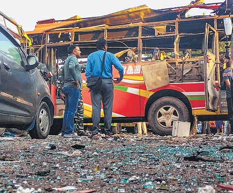 Officials inspect a bus that was damaged in the blast at Udhampur on Thursday | PTI