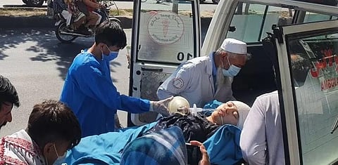 Relatives and medical staff shift a wounded girl from an ambulance outside a hospital in Kabul on September 30, 2022. (Photo | AFP)