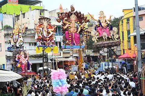 Lord Ganesha idols were immersed in beaches and artificial ponds across the country on the fifth day of the Ganpati festival on Sunday. IN PHOTO | Devotees take the idols of lord Ganesha from Shivajinagar in a grand procession for immersion in Bengaluru's