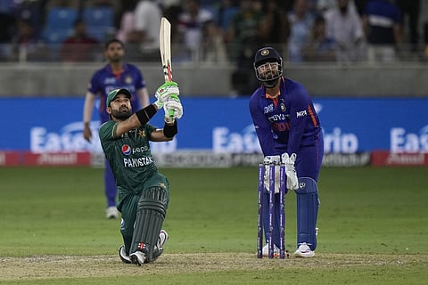 Pakistan's Mohammad Rizwan (left) follows the ball after playing a shot during the T20 cricket match of Asia Cup between India and Pakistan, in Dubai on Sunday. (Photo | PTI)