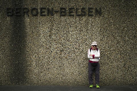 Israeli Olympic race walker Shaul Ladany poses for a photo at the entrance of the Nazi concentration camp Bergen-Belsen in Bergen, Germany, Saturday, Sept. 3, 2022. (Photo | AP)