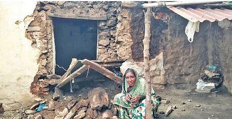 Villager Siddavva Parappanavar at her damaged house waiting for officials | Express