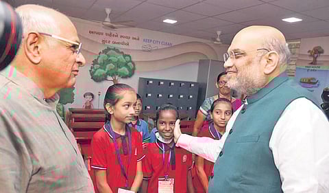 Union Home Minister Amit Shah with Gujarat Chief Minister Bhupendrabhai Patel during a visit to a school in Ahmedabad on Sunday. (Photo | EPS)
