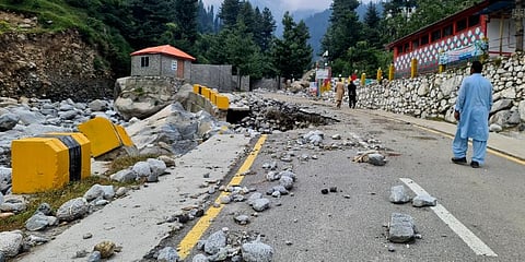 Local residents walk in the road destroyed by floodwaters in Kalam Valley in northern Pakistan. (Photo | AP)
