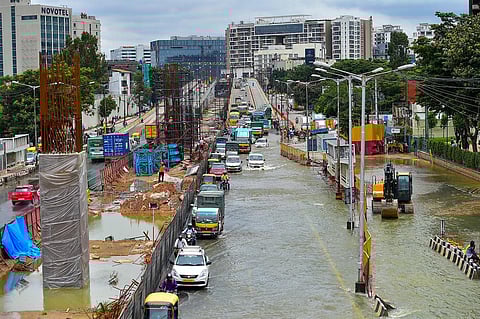 Vehicles wade through the waterlogged Outer Ring Road after heavy monsoon rains, in Bellandur, Bengaluru. (Photo | PTI)