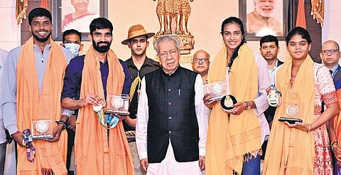 Governor Biswa Bhusan Harichandan felicitates four sportspersons at Durbar Hall in Raj Bhavan on Wednesday | Express