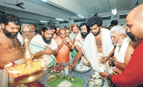 Thantri Kandararu Mahesh Mohanaru lighting the traditional lamp to mark the beginning of Onasadya at the Sabarimala temple | Shaji Vettipuram