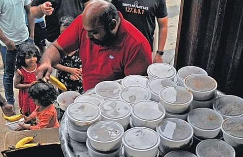 Volunteers distribute food to flood-hit residents of Bellandur | Vinod Kumar T