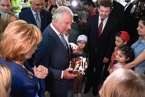 Britain's Prince Charles and Princess Margaret, offer presents to refugees during a visit at a center for refugees fleeing the war in neighboring Ukraine. (Photo | AP)