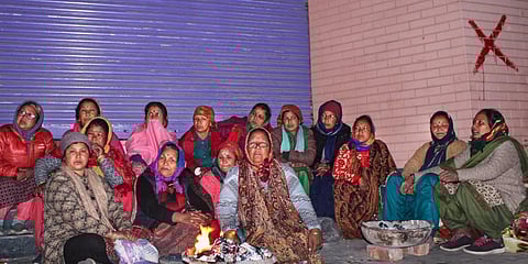 Locals protest against the demolision of the unsafe hotels and houses after cracks appeared at the landslide affected area of Joshimath, in Chamoli district. (Photo | PTI)