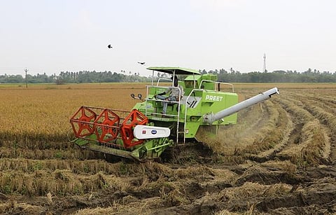 A harvester machine reaping crop near Kilvelur in Nagapattinam district | Express