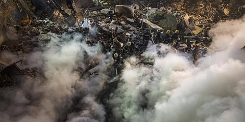 Emergency workers clear the rubble after a Russian rocket hit a multistory building leaving many people under debris in the southeastern city of Dnipro, Ukraine.(Photo| AP)