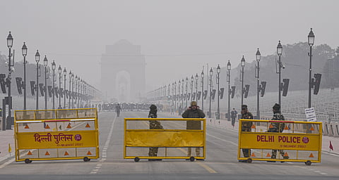 Security personnel stand guard at Kartavya Path as a contingent rehearses for the Republic Day Parade 2023 during a cold and foggy morning, in New Delhi, Saturday, Jan. 14, 2023. (Photo | PTI)