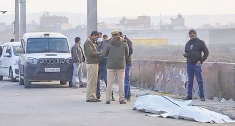 Police inspect a drain where body parts of a man were found in north Delhi