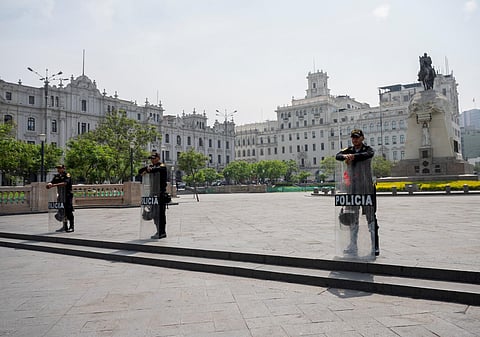 Peruvian riot police stand guard at Plaza San Martin, a main gathering place in downtown Lima, on January 19, 2023. (Photo | AFP)