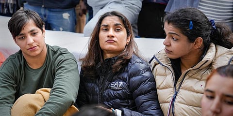 Wrestlers Vinesh Phogat, Sakshi Malik and Anshu Malik sit on 'dharna' to protest against the Wrestling Federation of India (WFI), at Jantar Mantar. (Photo | PTI)