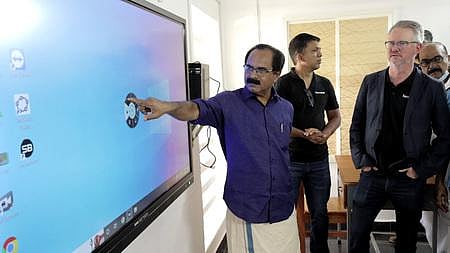 MLA D K Murali and company representatives in a smart classroom at the Government Tribal High School in Idinjar. (Photo | EPS)