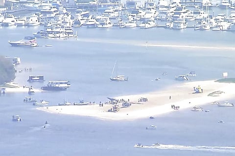 The image shows sand bank with crashed helicopter on Gold Coast, Australia on January 2, 2023. (Photo | AP)