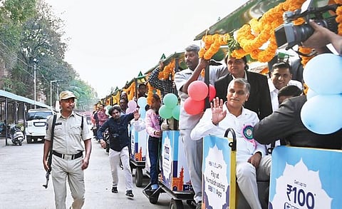 Minister T Harish Rao waves as he take a train ride after inaugurating the  82nd All India Industrial Exhibition at Nampally Exhibition Grounds in  Hyderabad on Sunday;Vinay Madapu