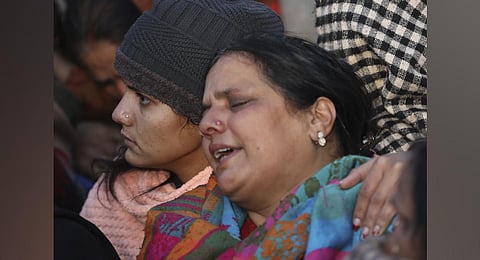 Family members mourn after four civilians were gunned down by unidentified men on Sunday evening, in Dhangri area of Rajouri (Photo | PTI)