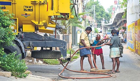 A file pic of corporation workers clearing the underground drainage system blockage in Tiruchy using the existing equipment. (Photo |M K Ashok Kumar, EPS)