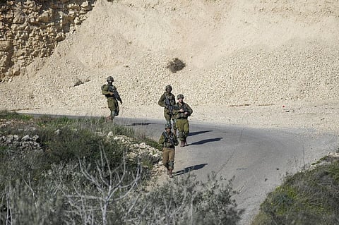 Israeli soldiers patrol the scene after a Palestinian was shot and killed following an alleged attempted attack on an Israeli, next to Sde Efraim farm in the West Bank. (Photo | AP)