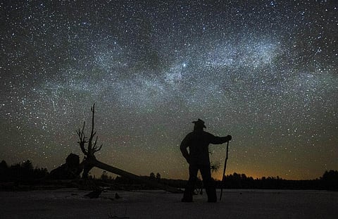 Dave Cooke observes the Milky Way over a frozen fish sanctuary in central Ontario, north of Highway 36 in Kawartha Lakes, Ontario, Canada, early Sunday on March 21, 2021. (File Photo | AP)