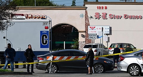 Local residents watch police investigate the scene of a mass shooting in Monterey Park, California. (Photo | AFP)