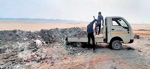 Garbage being dumped from a small goods carrier on Kathajodi riverbed in Cuttack  | Express