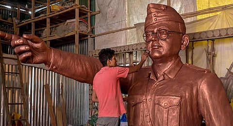 An artisan works on a fibre glass model of Netaji Subhas Chandra Bose at his workshop ahead of his 126th birth anniversary, at Santipur in Nadia. (Photo | PTI)