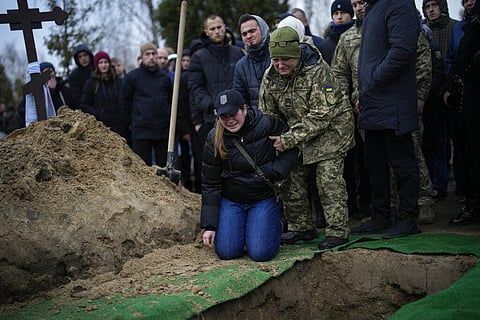 Anya Korostenska drops to her knees at the grave of her fiance Oleksiy Zavadskyi, a Ukrainian serviceman who died in combat on January 15 in Bakhmut. (Photo | AP)