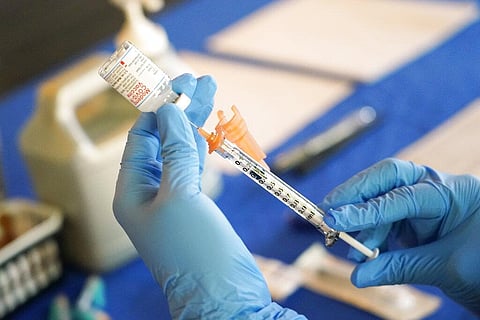 A nurse prepares a syringe of a COVID-19 vaccine at an inoculation station in Jackson, Miss., July 19, 2022. (Photo | AP)
