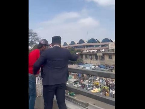 A man showered money from a flyover in Bengaluru.
