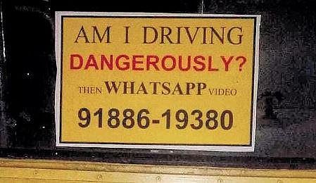 A sticker with the WhatsApp number pasted on the rear of a KSRTC bus