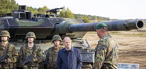 German Chancellor Olaf Scholz stands with German army Bundeswehr soldiers at a 'Leopard 2' main battle tank during a training and instruction exercise in Ostenholz, Oct. 17, 2022. (File Photo | AP)
