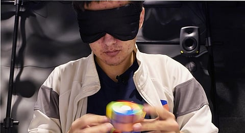 University of Michigan student Stanley Chapel solves a Rubik's Cube while blindfolded. (Photo | AP)