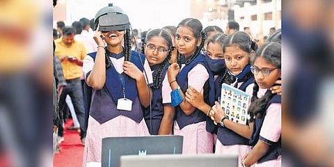​  A girl student enjoys a virtual reality experience during the Science Expo 2023 at Palace Grounds in Bengaluru 