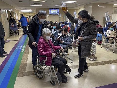 An elderly patient is pushed along a corridor of the emergency ward providing intravenous drips, in China. (Photo | AP)
