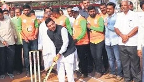 Union Minister Pralhad Joshi plays cricket at the outdoor stadium in Gadag town on Monday