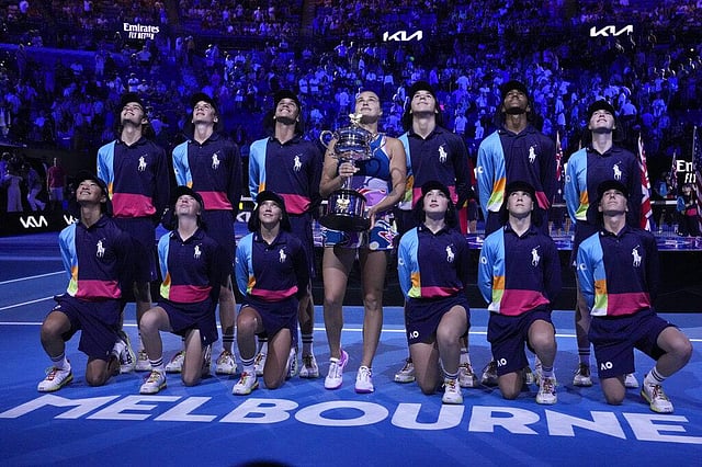Sabalenka holds the Daphne Akhurst Memorial Trophy with the ball kids after defeating Rybakina in the women's singles final at the Australian Open tennis championship in Melbourne, Australia. (Photo | AP)