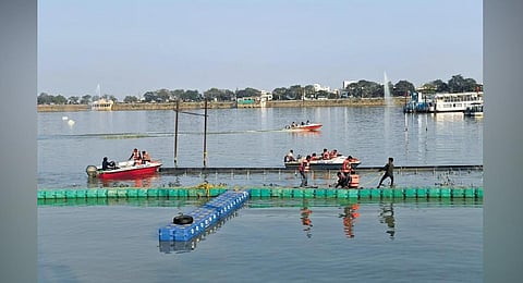 Workers install floating musical fountains in the picturesque Hussainsagar lake | Vinay Madapu