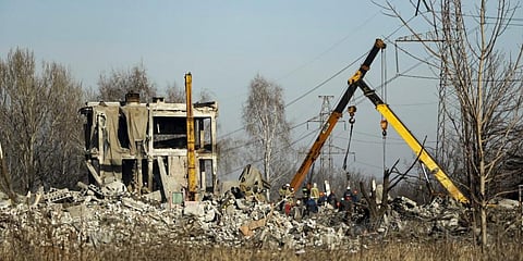 Workers clean rubbles after Ukrainian rocket strike in Makiivka, in Russian-controlled Donetsk region, eastern Ukraine. (Photo | AP)